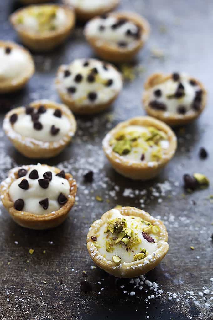 cannoli bites topped with either chocolate chips or pistachios.