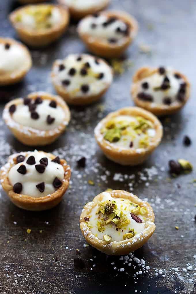 cannoli bites topped with either chocolate chips or pistachios.