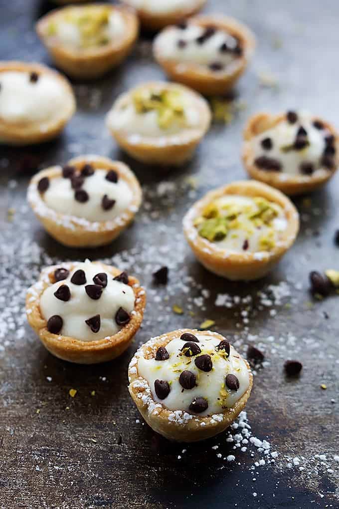 cannoli bites topped with either chocolate chips or pistachios.