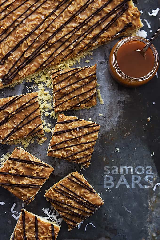 top view of Samoa bars with a jar of caramel with a spoon and the title of the recipe written on the bottom right of the image.