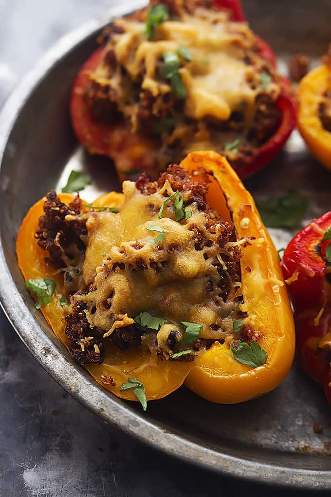 close up of slow cooker southwest quinoa stuffed peppers in a round serving tray.