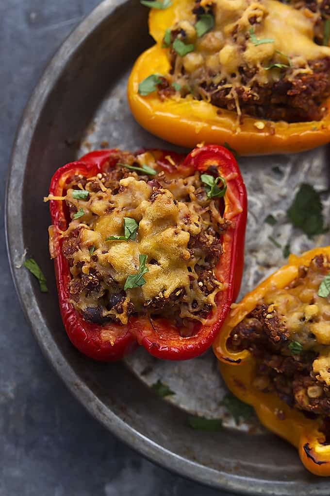 top view of slow cooker southwest quinoa stuffed peppers on a round serving tray.