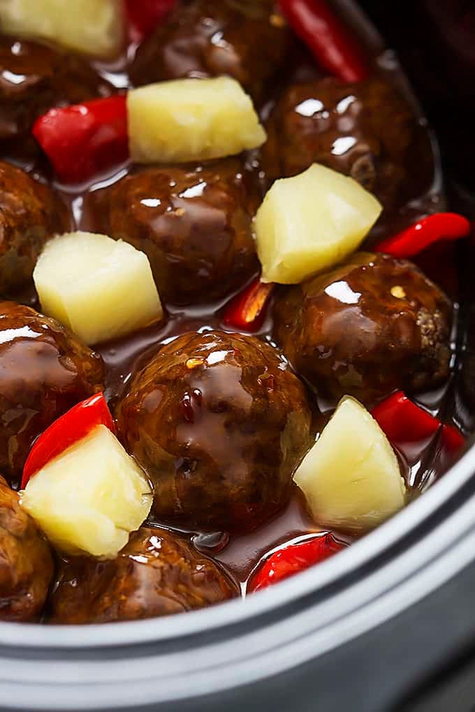 close up of slow cooker sweet & sour meatballs in a slow cooker.