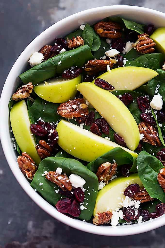 top view of apple cherry candied pecan salad with sweet balsamic dressing in a bowl.