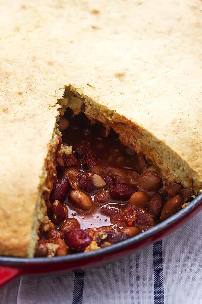close up of Chili cornbread skillet pie with a slice missing in a skillet.
