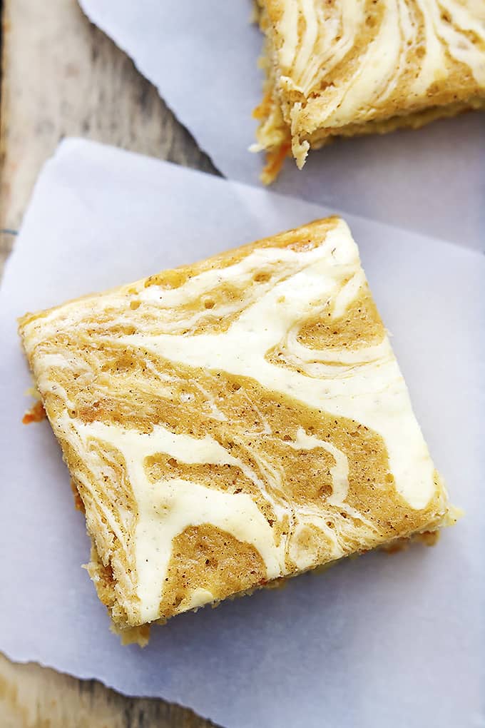 top view of a cream cheese swirled carrot cake bar with another bar on the side.