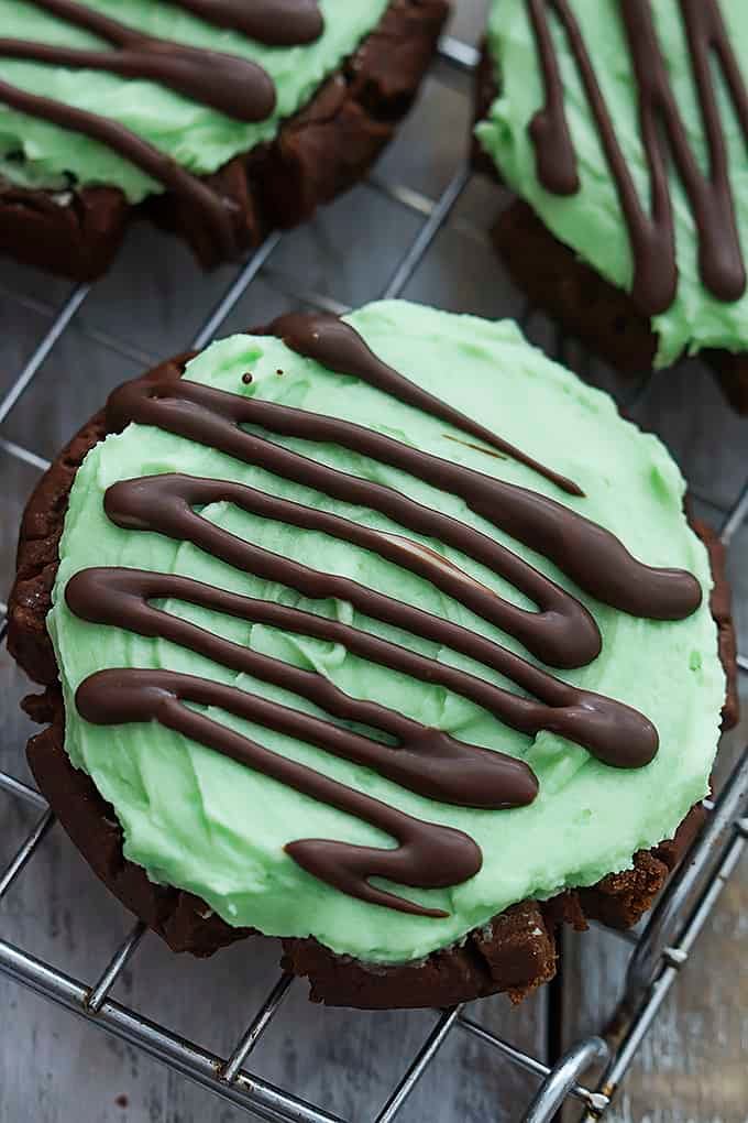 close up of a grasshopper sugar cookie with more cookies on the side.