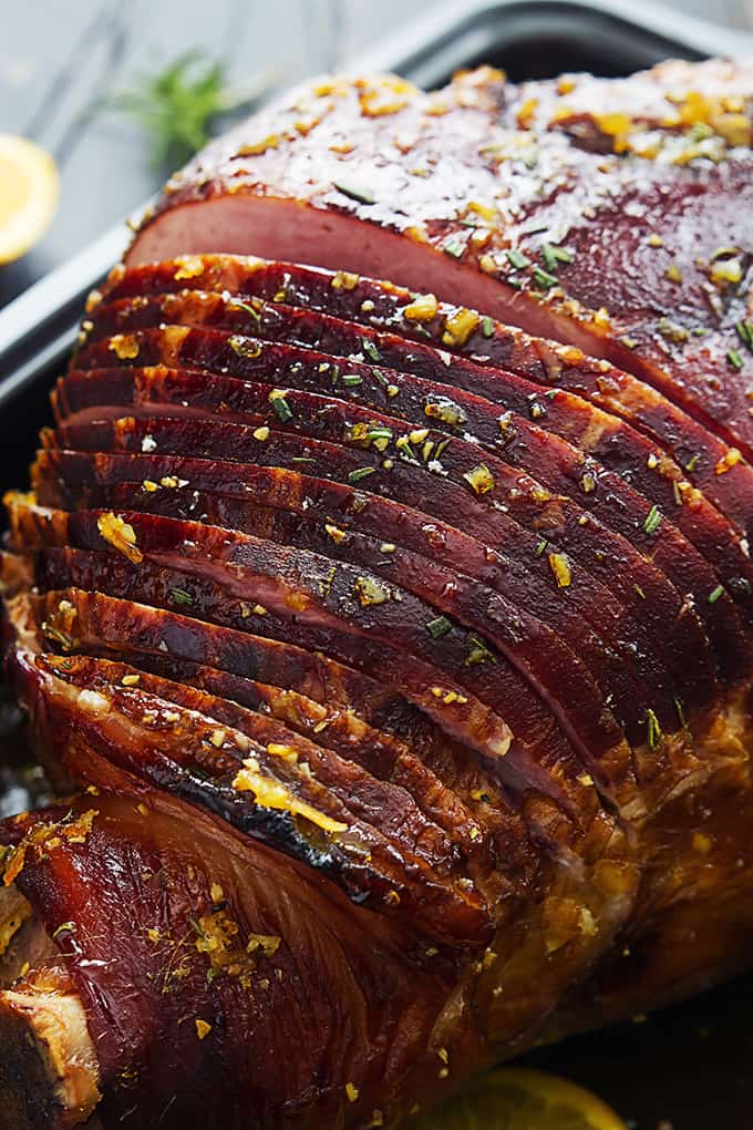 close up of rosemary citrus ham in a cooking pan.