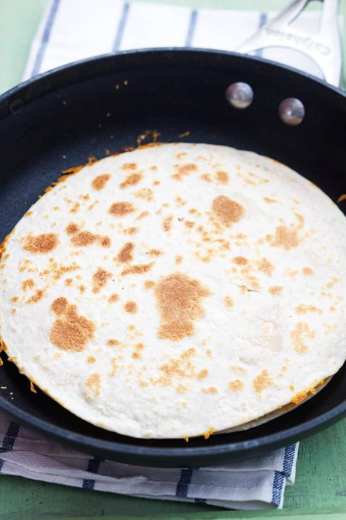 a slow cooker chicken quesadilla in a skillet.