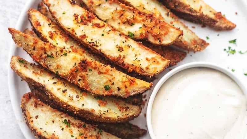 overhead baked potato wedges with ranch on white plate