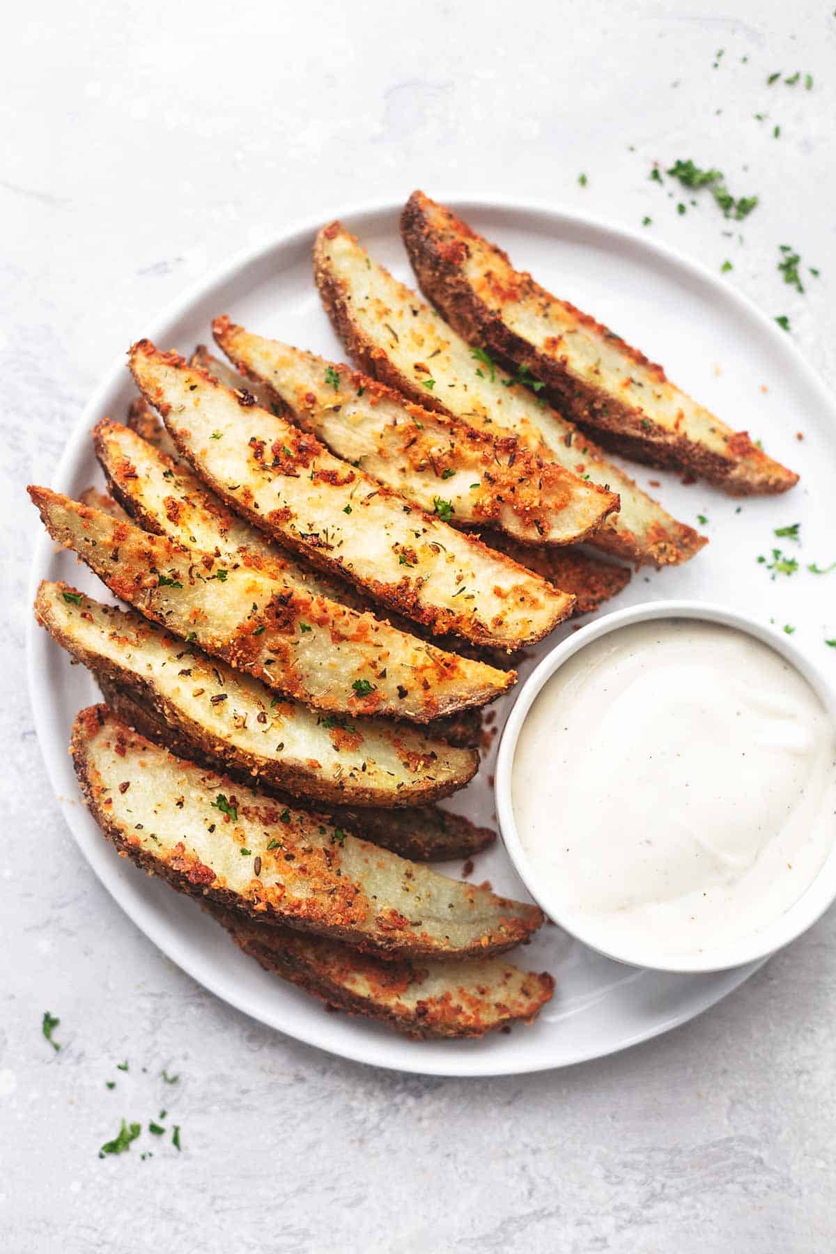 overhead baked potato wedges with ranch on white plate