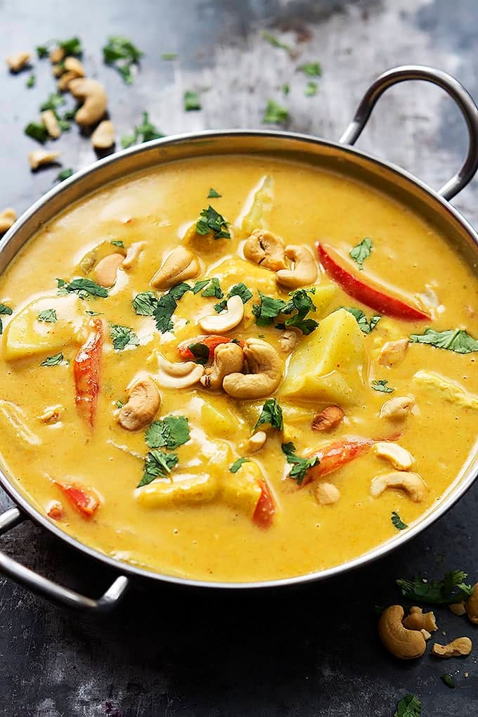 slow cooker coconut curry cashew chicken in a cooking pan.