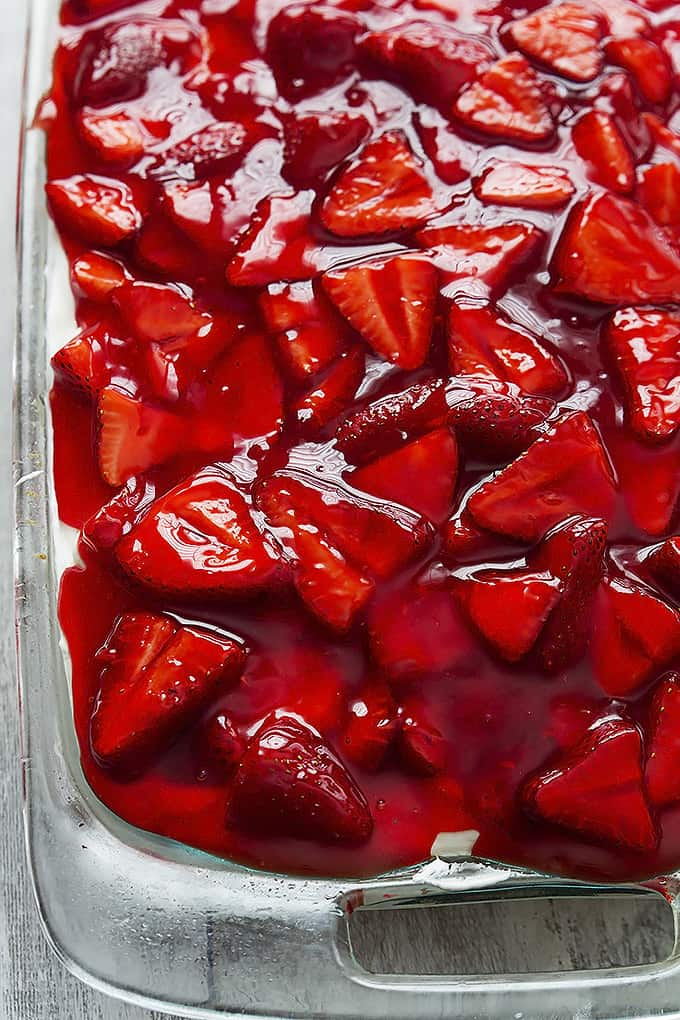 strawberry poppyseed cake in a glass pan.