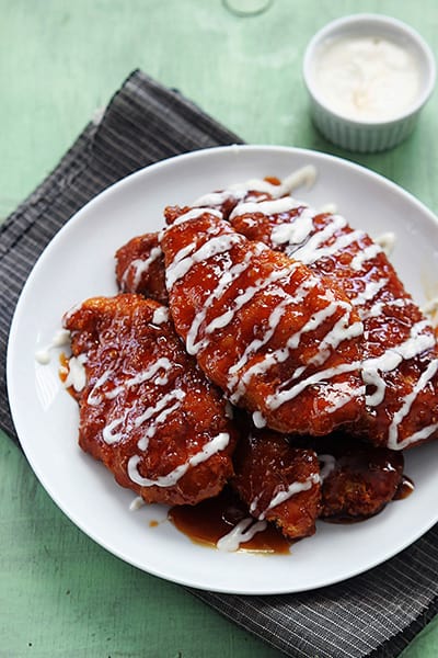 copycat Winger's sticky fingers on a plate with a small bowl of dipping sauce on the side.