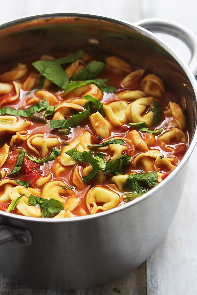 tomato spinach tortellini soup in a cooking pot.
