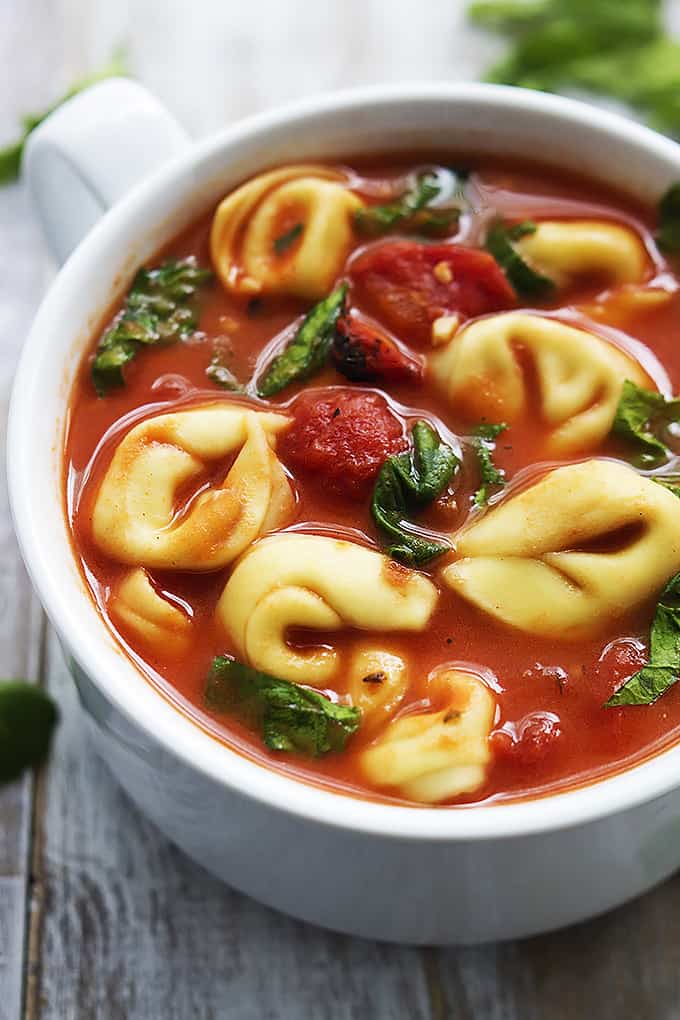 tomato spinach tortellini soup in a bowl.
