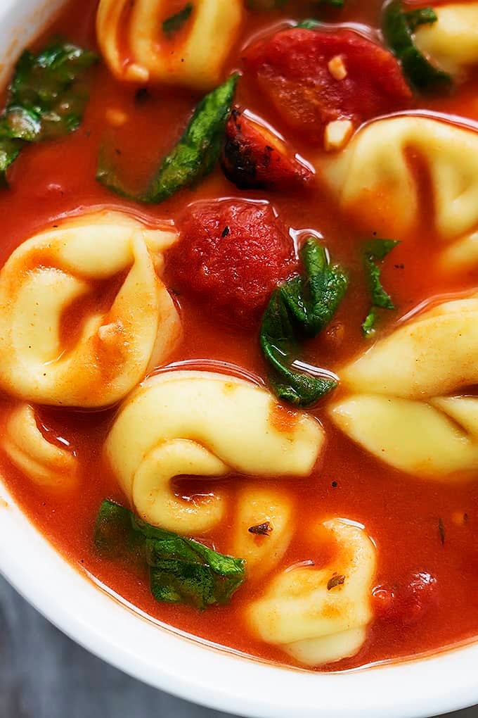 close up of tomato spinach tortellini soup in a bowl.