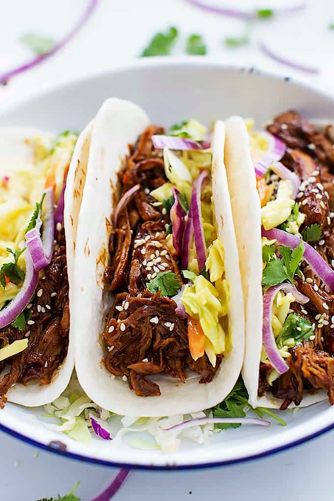 slow cooker Korean bbq pork tacos on a plate.