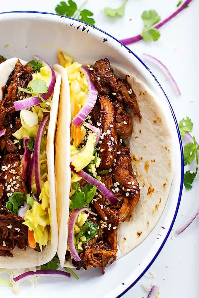 close up top view of slow cooker Korean bbq pork tacos on a plate.