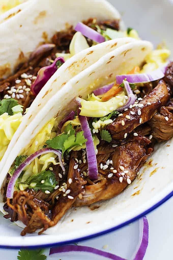 close up of slow cooker Korean bbq pork tacos on a plate.