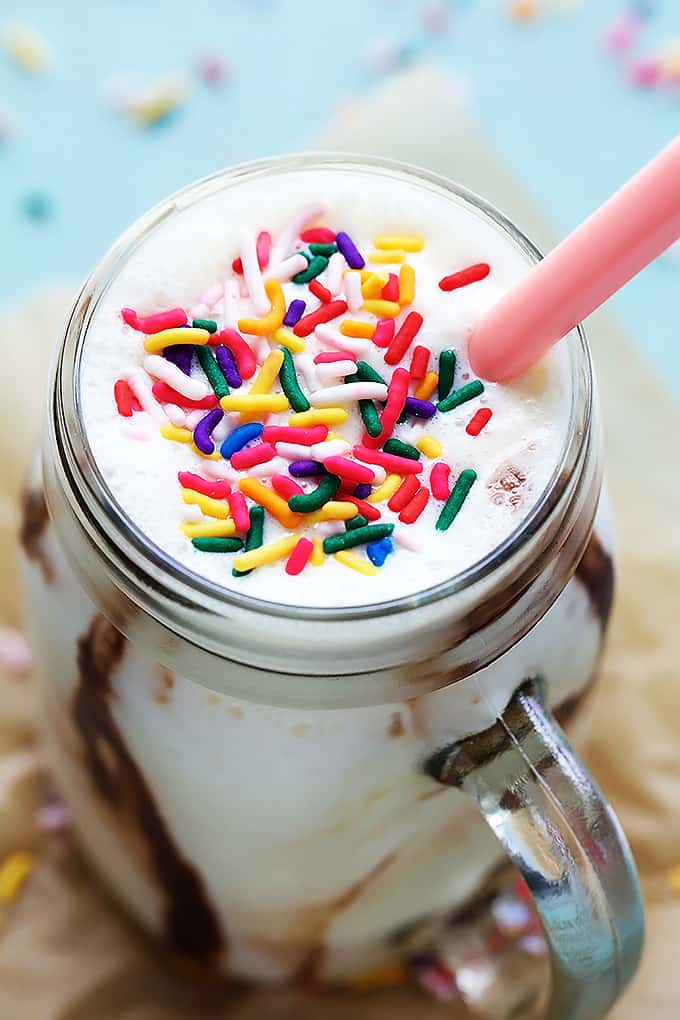 close up top view of cake batter smoothie with a pink spoon in a mason jar.
