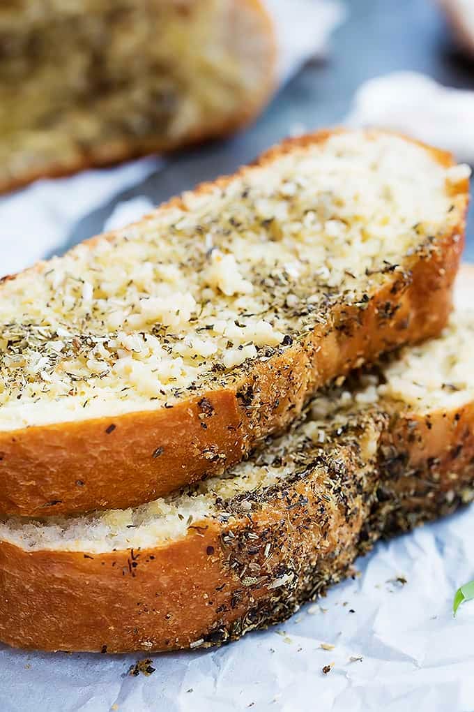 two slices of grilled garlic bread stacked on top of each other.