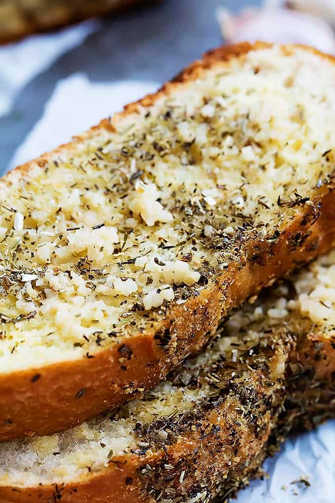 close up of two slices of grilled garlic bread stacked on top of each other.