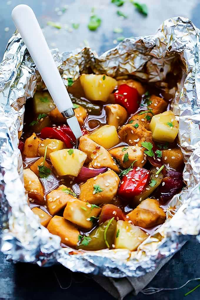 a pineapple chicken foil packet with a fork inside.