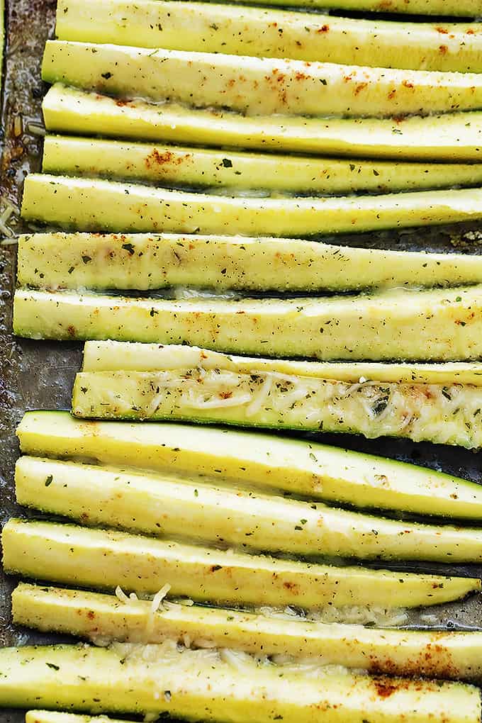 close up of baked cheesy ranch zucchini on a baking sheet.