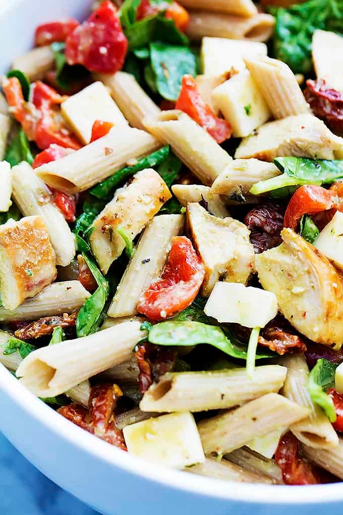 close up of chicken penne salad with creamy parmesan dressing in a bowl.