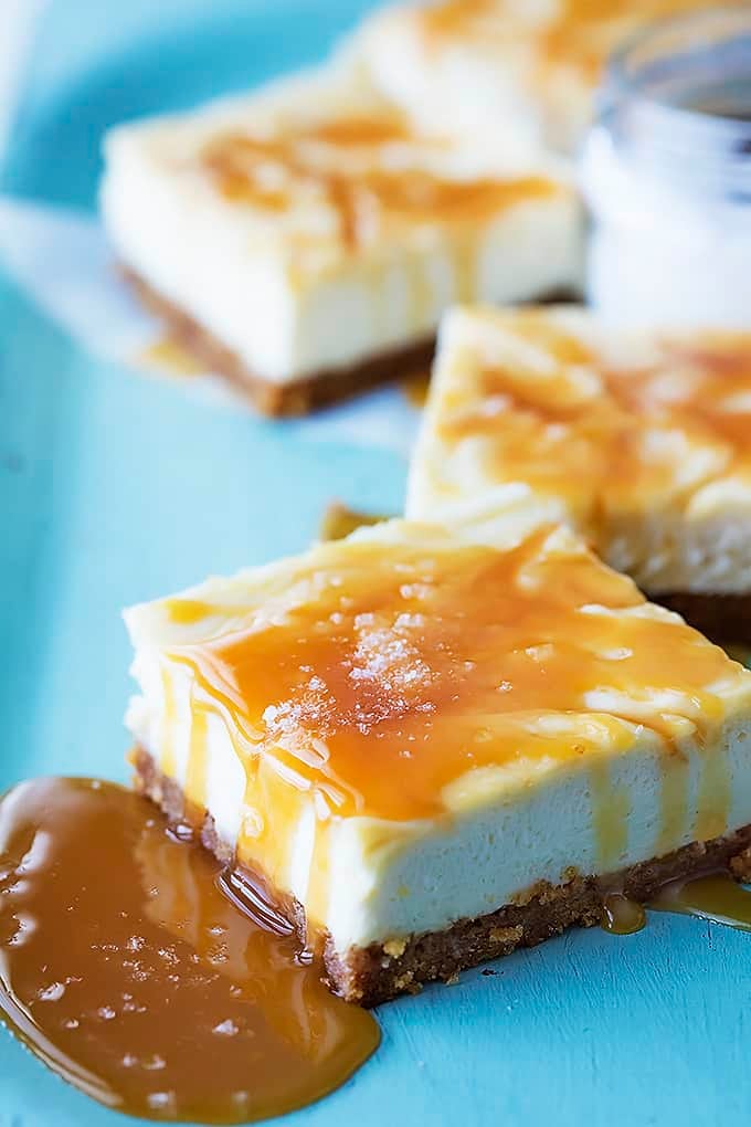 a salted caramel cheesecake bar with more bars in the background.