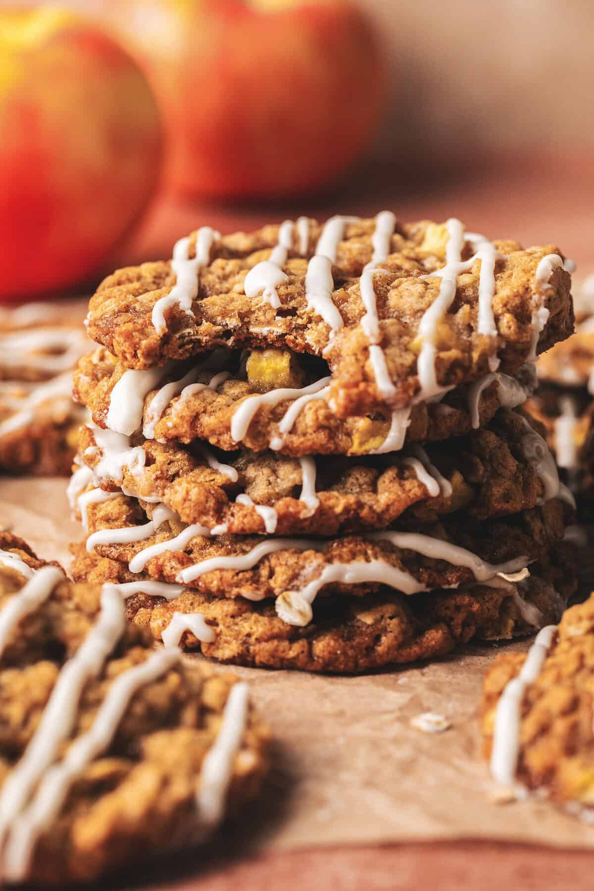 A stack of apple oatmeal cookies with a bite gone from the top cookie.