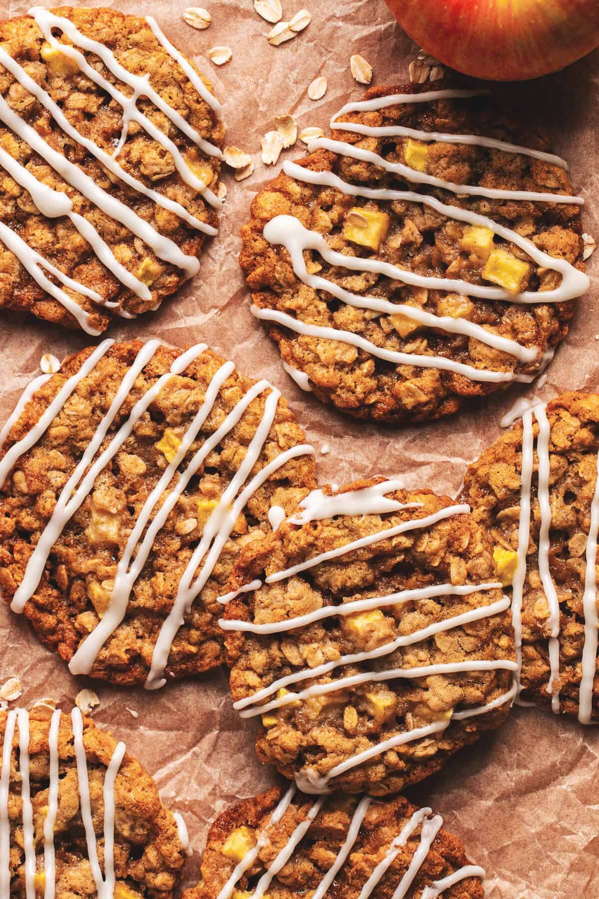 Overhead of apple oatmeal cookies drizzled with apple cream cheese frosting.