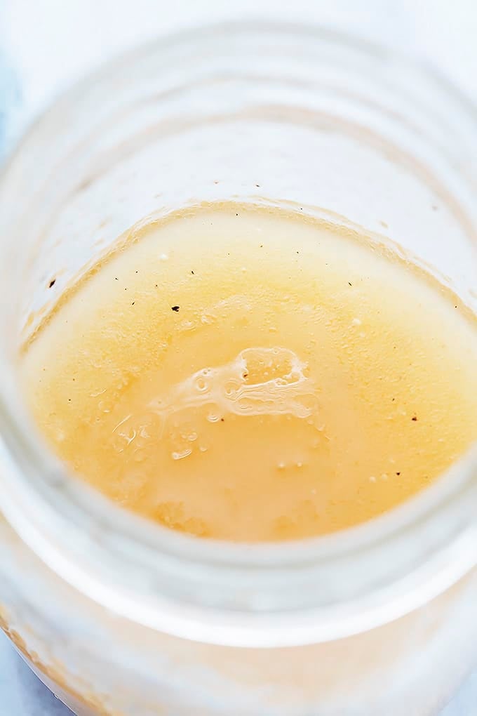 close up of maple vinaigrette in a mason jar.