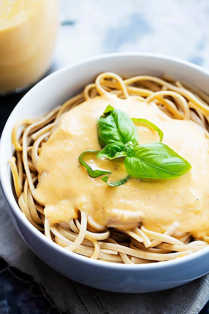 butternut squash pasta sauce on top of pasta in a bowl.