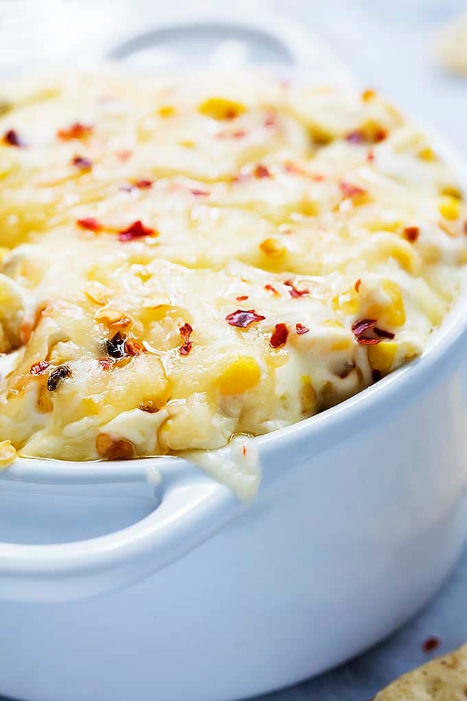 close up of a bowl of hot cheesy corn dip.