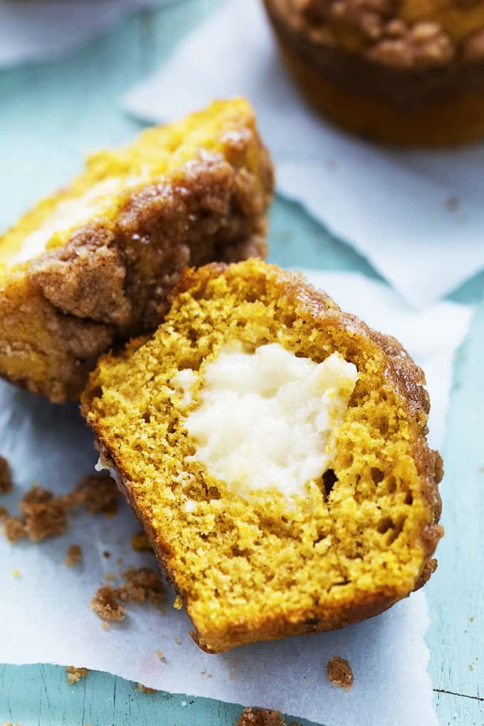 a pumpkin cream cheese streusel muffin cut in half and laid on it's side.