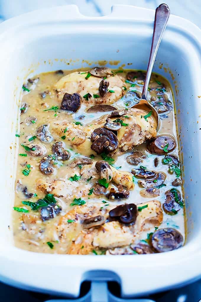 slow cooker chicken marsala and a spoon in a baking tray.