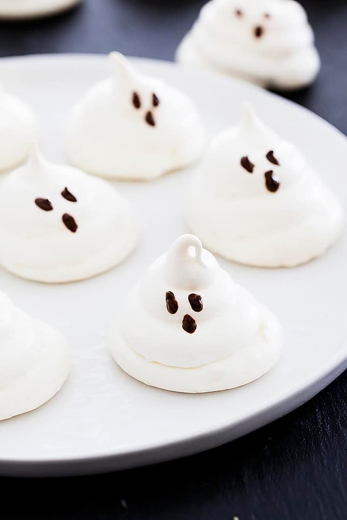 almond meringue ghost cookies on a plate.