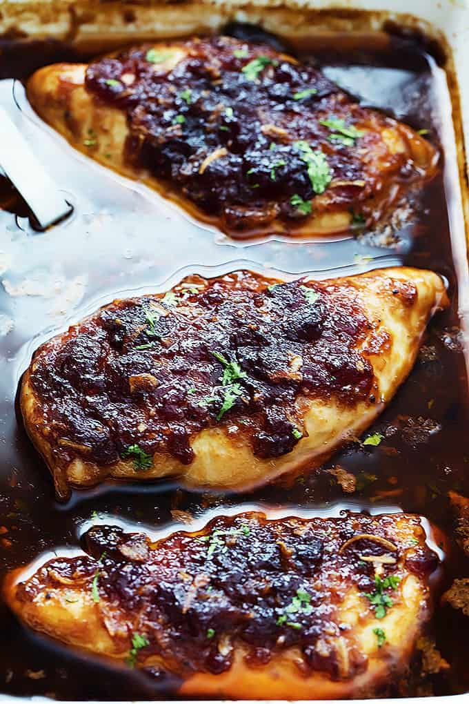 slow cooker cranberry chicken in a serving tray.