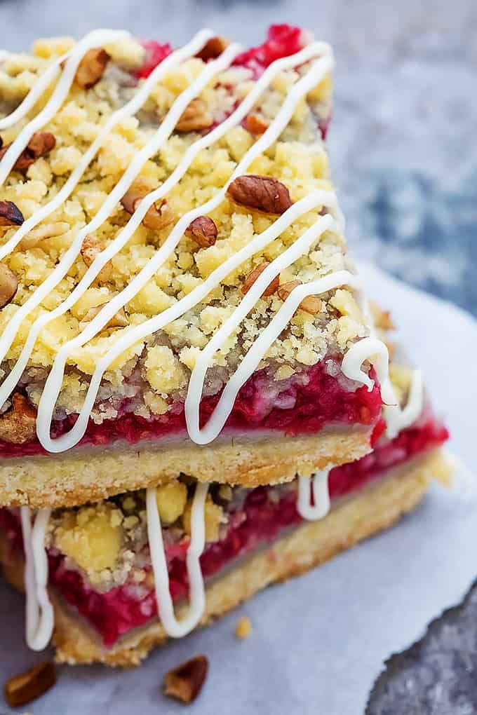 close up of stacked raspberry crumb pie bars.