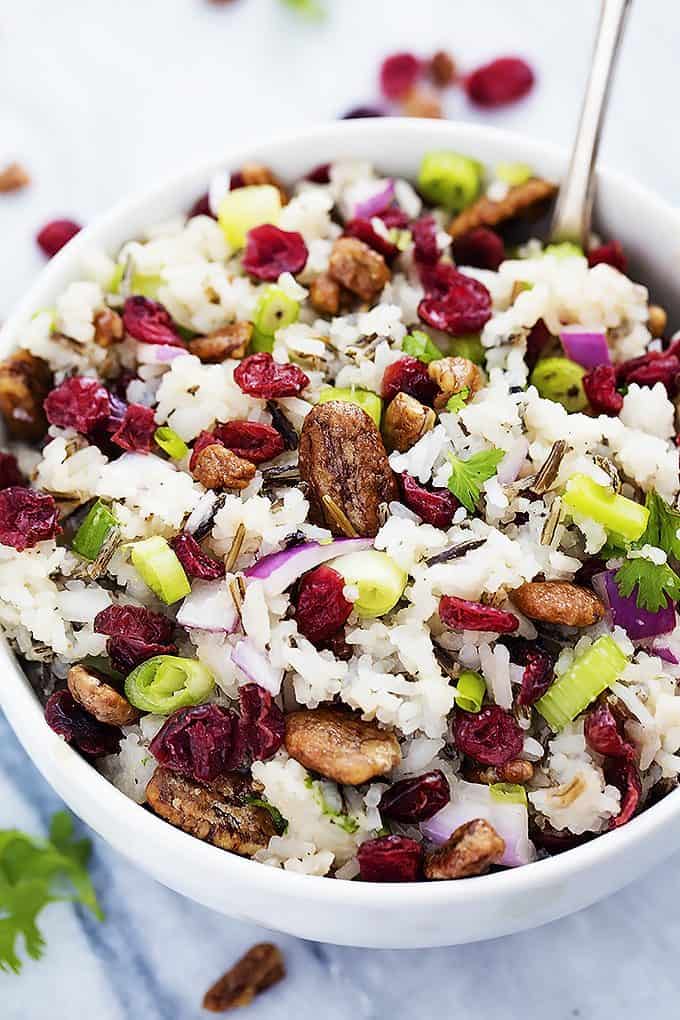 cranberry pecan wild rice salad and a spoon in a bowl.