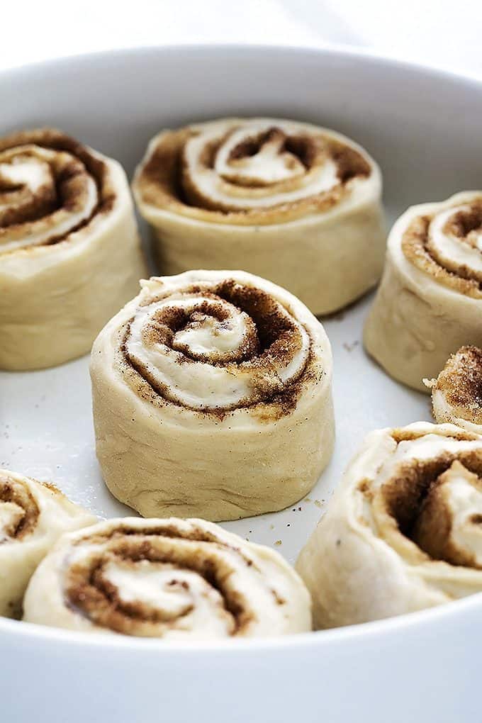 uncooked mashed potato cinnamon rolls in a round dish.
