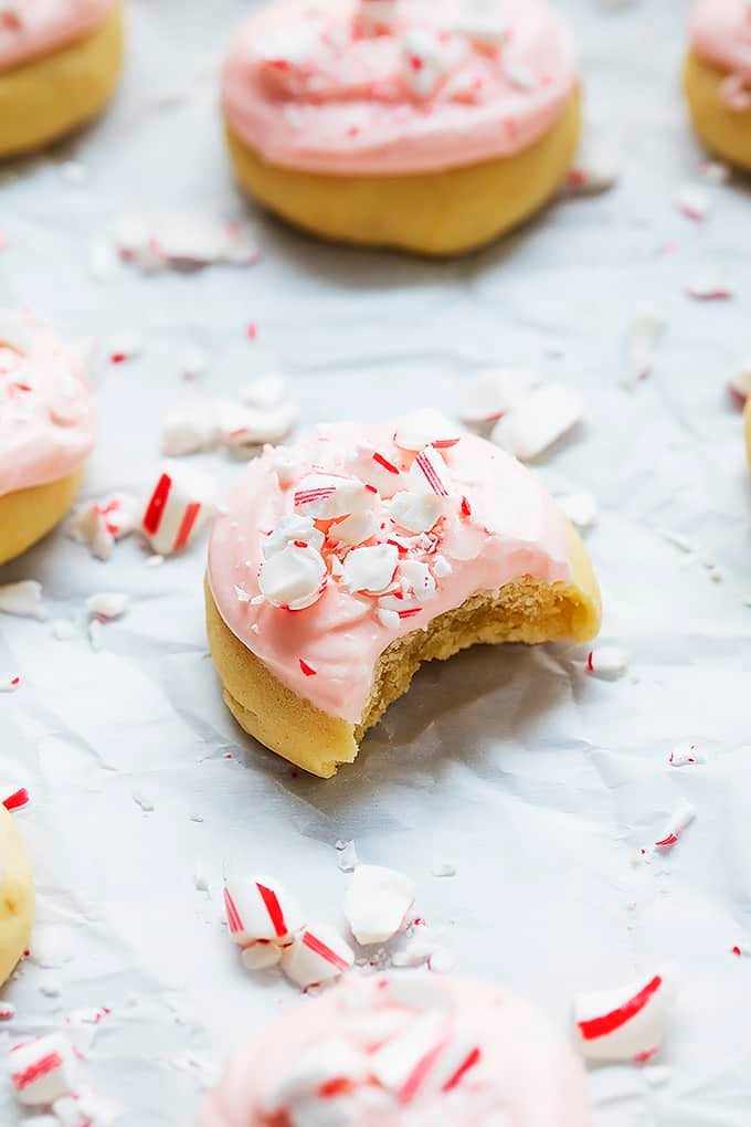 a peppermint meltway cookie with bite missing and more cookies around it.