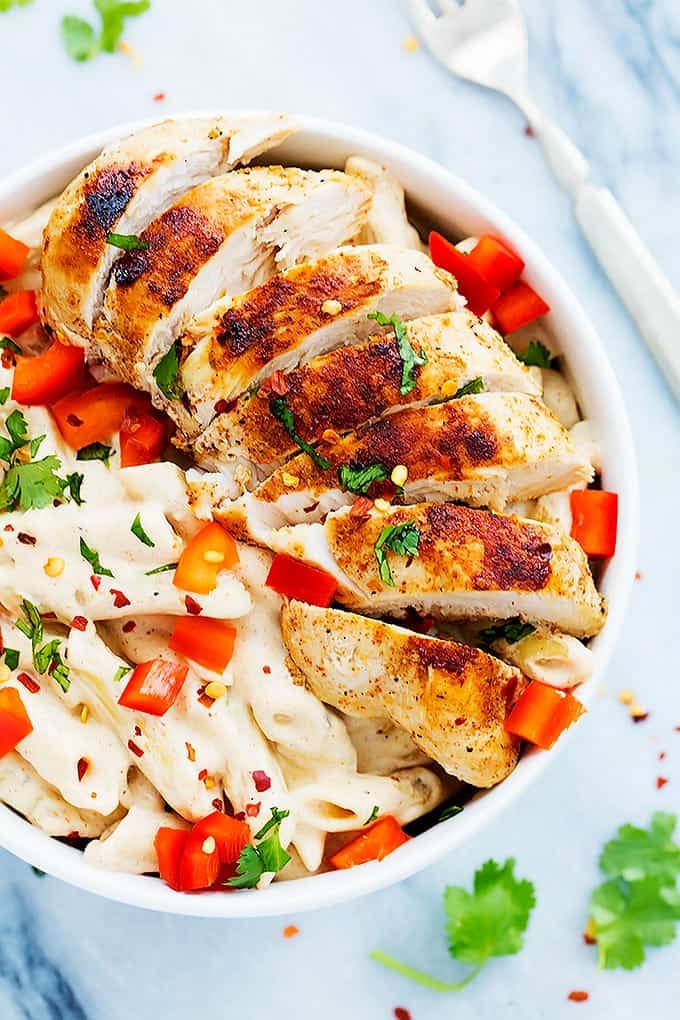 top view of Chili's cajun alfredo pasta in a bowl with a fork on the side.