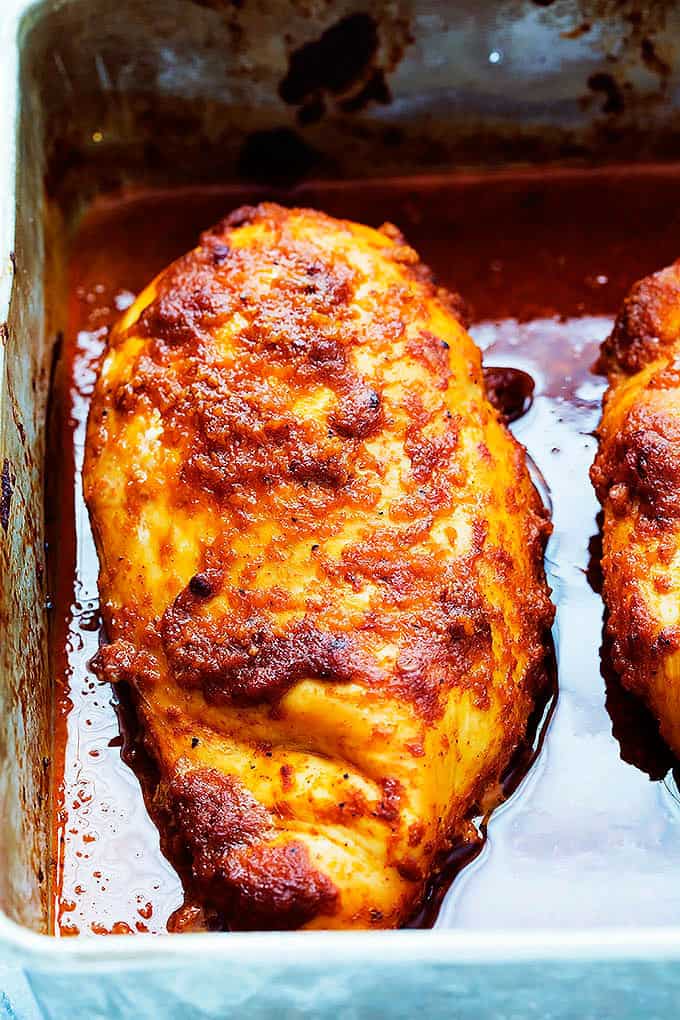 close up of baked chipotle chicken in a baking pan.