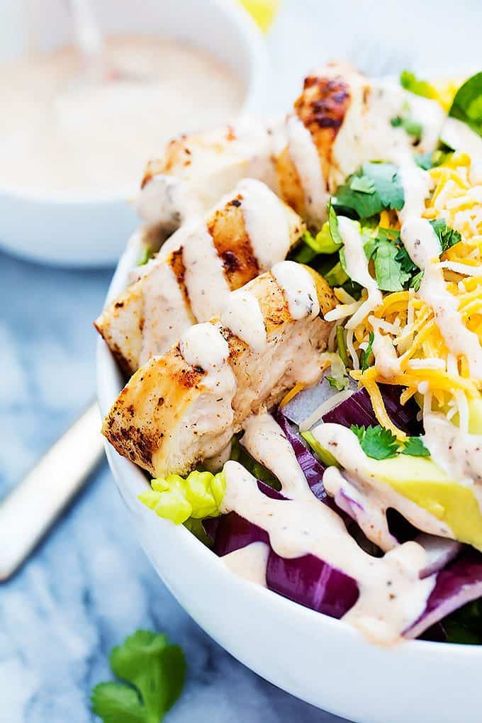 close up of Southwest chicken salad in a bowl with more dressing on the side.