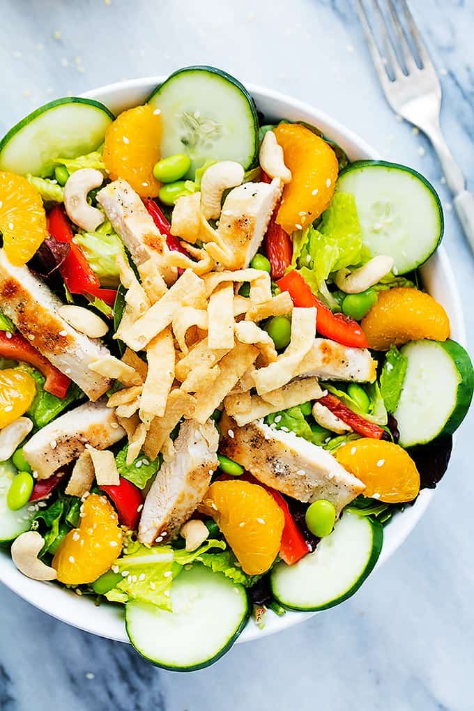 top view of Asian citrus chicken salad in a bowl with a fork on the side.