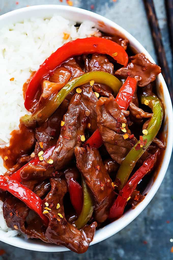 close up top view of Beijing beef with rice in a bowl.