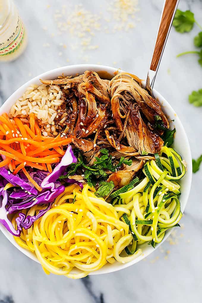 top view of a slow cooker luau pork rice bowl with a fork.